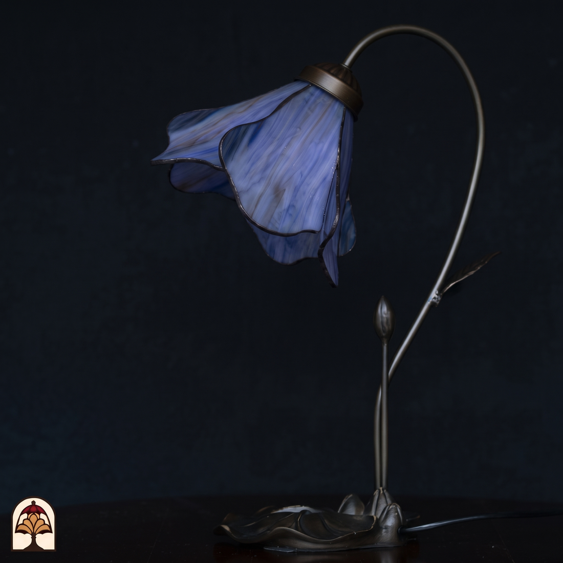 Tiffany tafellamp Lotus Viola ⌀20 cm – onverlicht op donkere achtergrond, paarse bloemkap en bronzen voet