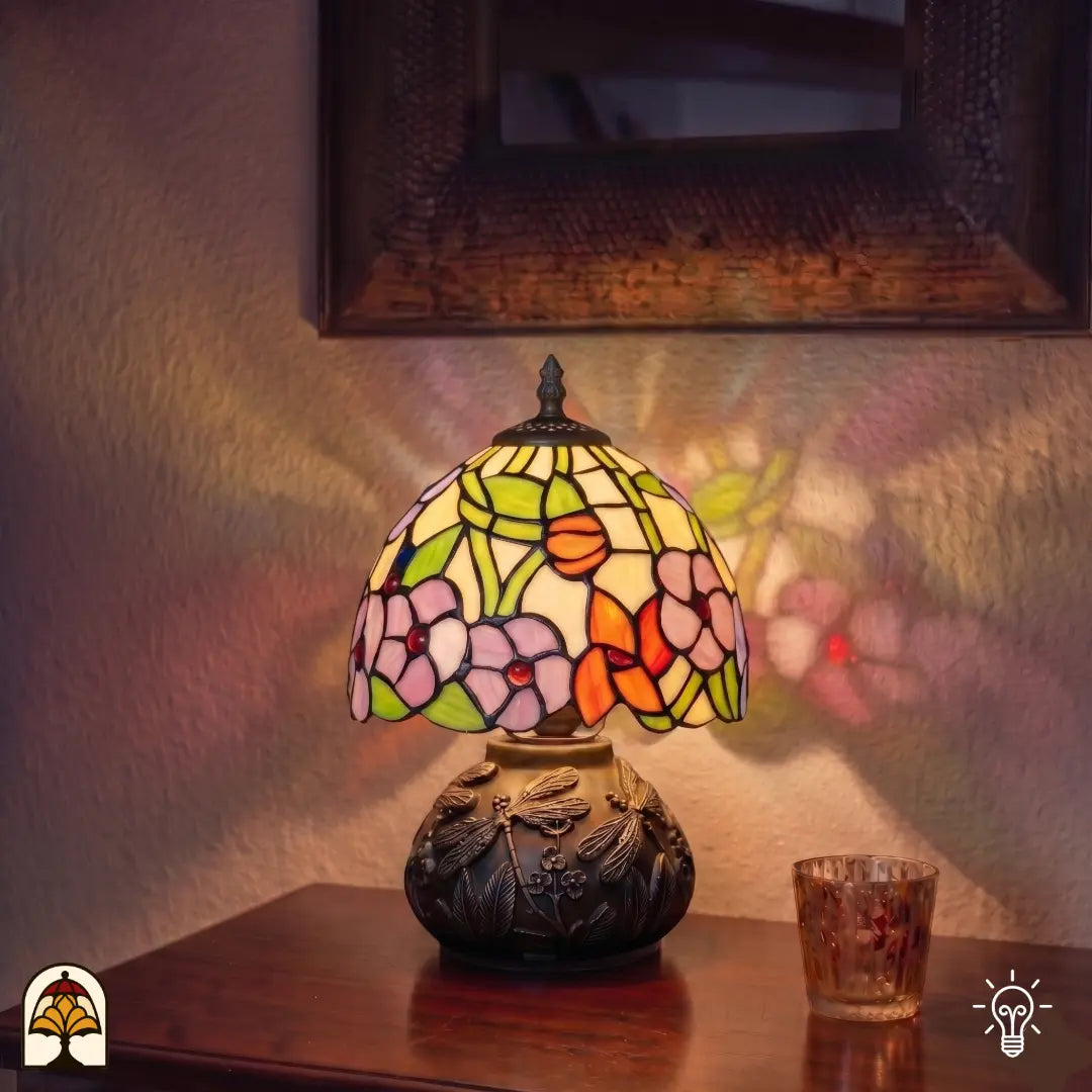 Lampe de table Tiffany Amber Flora Classic ⌀20 cm allumée dans un intérieur chaleureux – abat-jour à motifs de fleurs roses sur vitrail coloré, lumière chaude