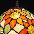 Close-up lampenkap Solea Radix – oranje zonnebloemblaadjes en geel hart in glas-in-lood