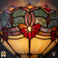 Tiffany wandlamp Giglio Rubino in interieur – warm rood-geel lichtspel op muur